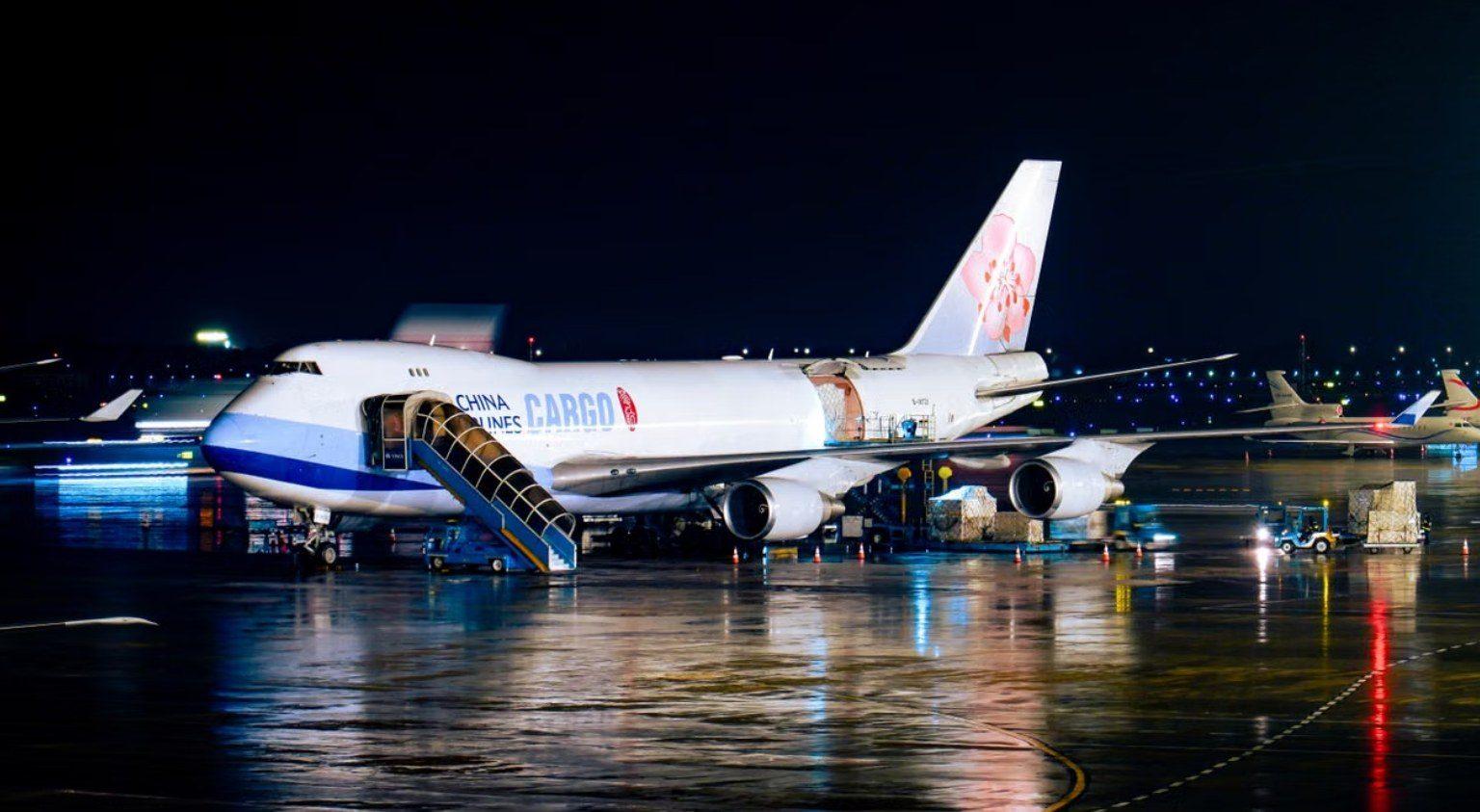 Cargo aircraft being loaded at night