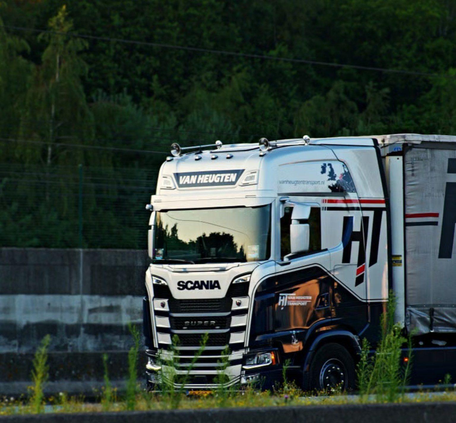 HGV tractor unit on a tree-lined dual carriageway